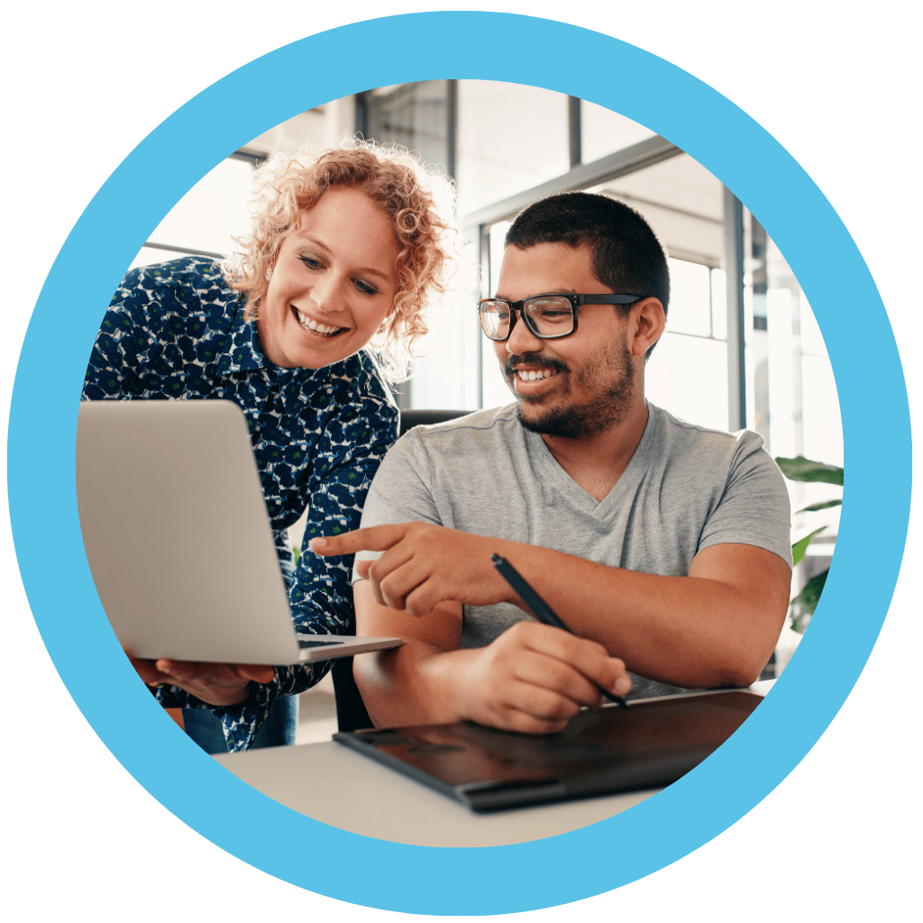 Two people reviewing Virtuous on a computer